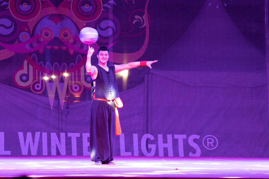 Performer spinning jug on finger at Magic Winter Lights, La Marque, TX