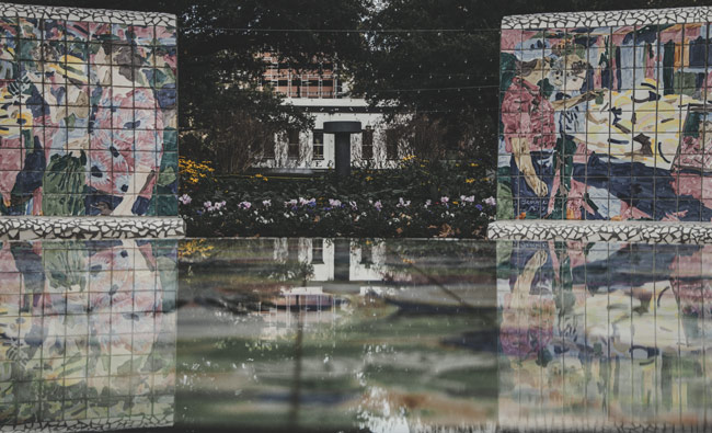 Frescos reflected in pool of water, Houston, TX